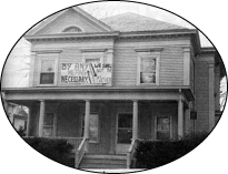 April 1988, Dean's Office Takeover of the Jenness House--then the President's office. The photograph is in black and white and the signs posted on the house in the picture are difficult to read.