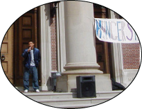 In 2001 the students held a Hunger Strike for Latino Studies. This photograph is from that event as a student leader speaks near the columns of Chapin. The photograph is in color.